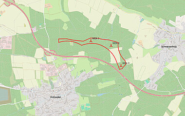 Geländedarstellung mit Windkraftanlagen und topographischen Details.