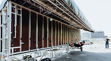 Techniker inspiziert eine Baustelleneinrichtung auf einem Parkplatz.