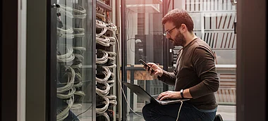 Techniker überprüft Serverausrüstung in einem Rechenzentrum.